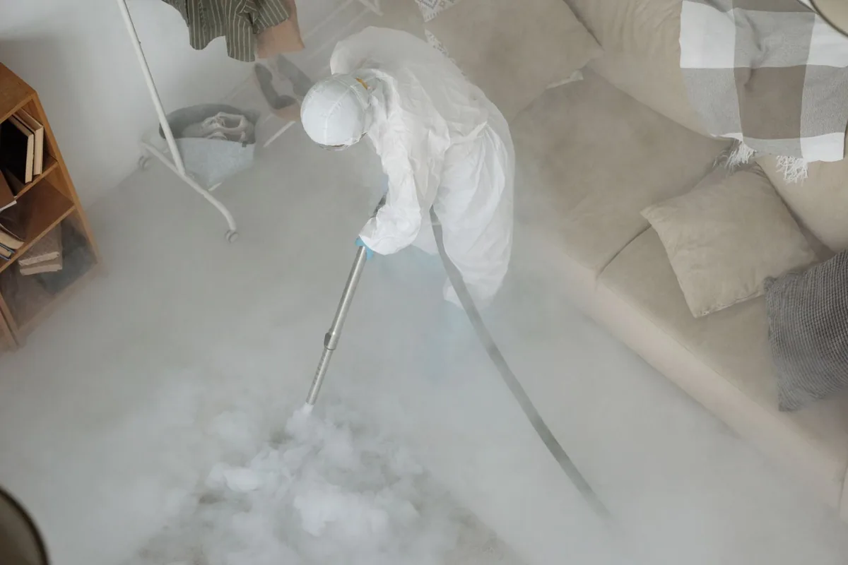 Biohazard cleanup technician in protective equipment, Fulton, MO